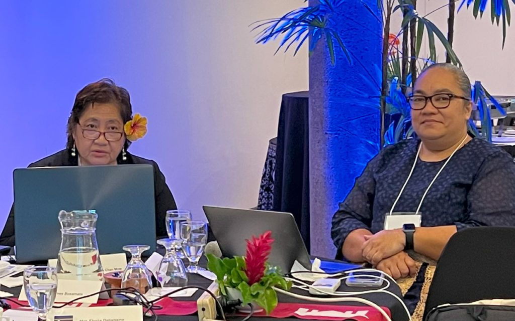 Two participants pose for a photograph at the meeting