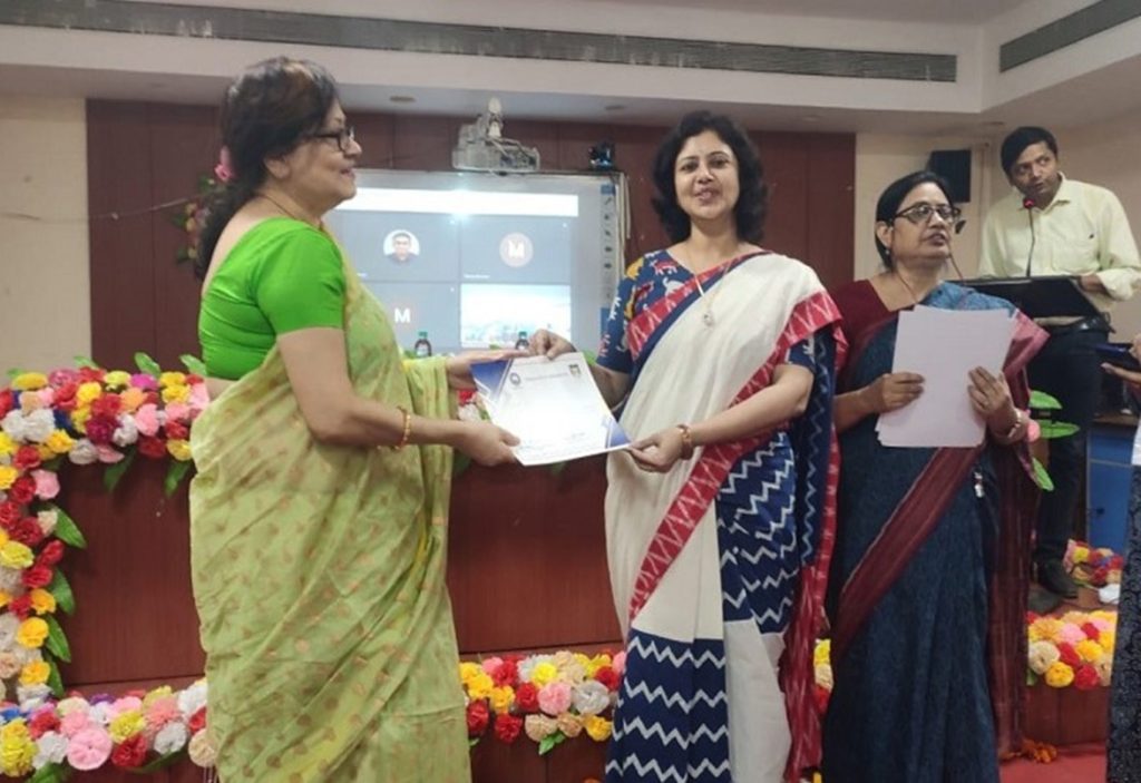 Participant receiving certificate at the workshop