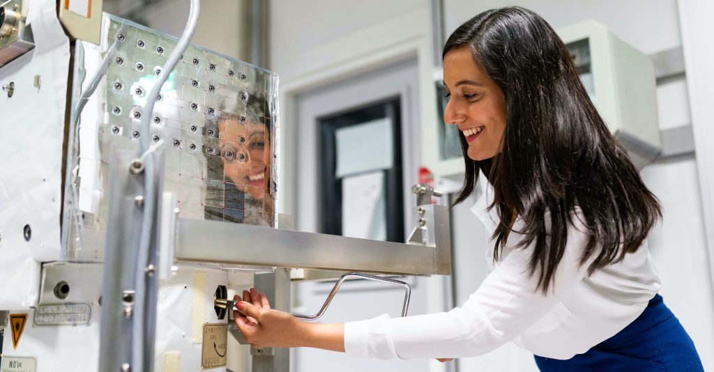 woman working with high tech machine in a lab