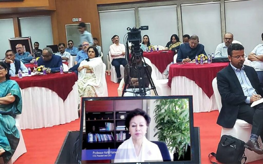 Presenter Professor Kanwar displayed on a laptop screen in the foreground at the Vice-Chancellors' Forum