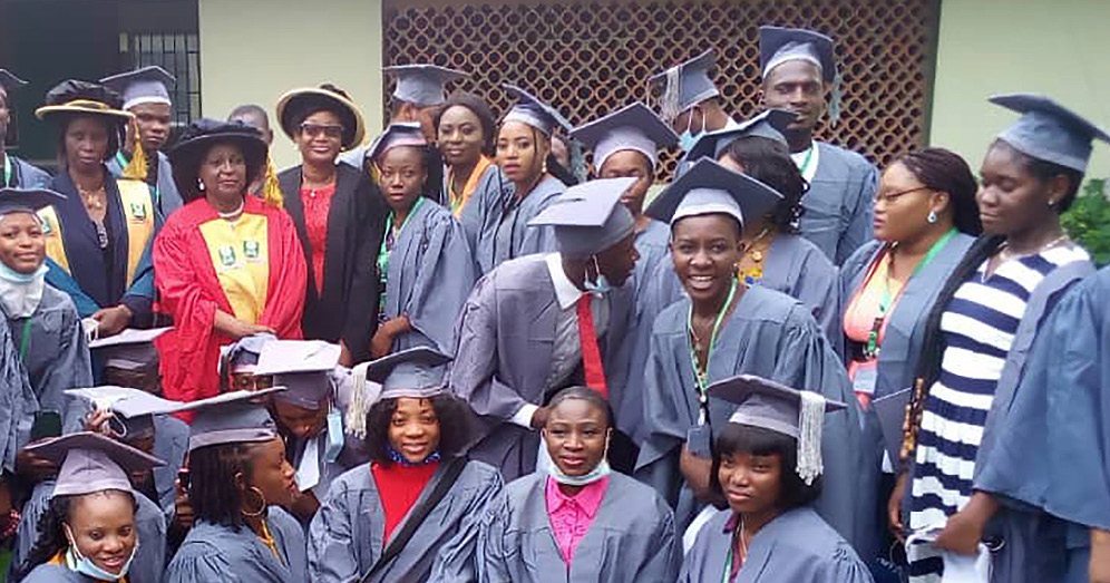 group of university graduates in cap and gowns